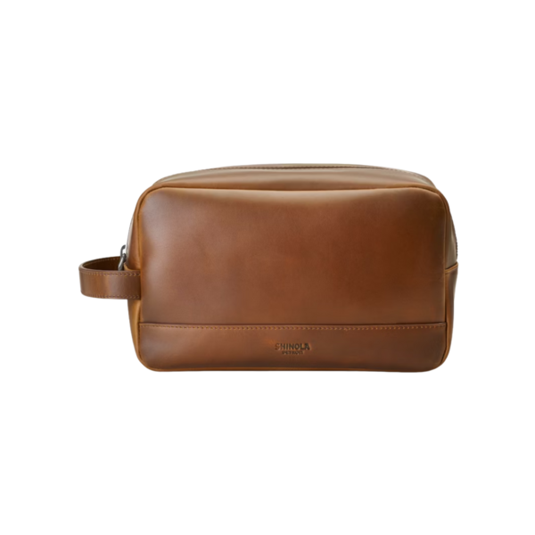 Product and lifestyle images of Shinola Zip Travel Kit, one in person's hand for scale